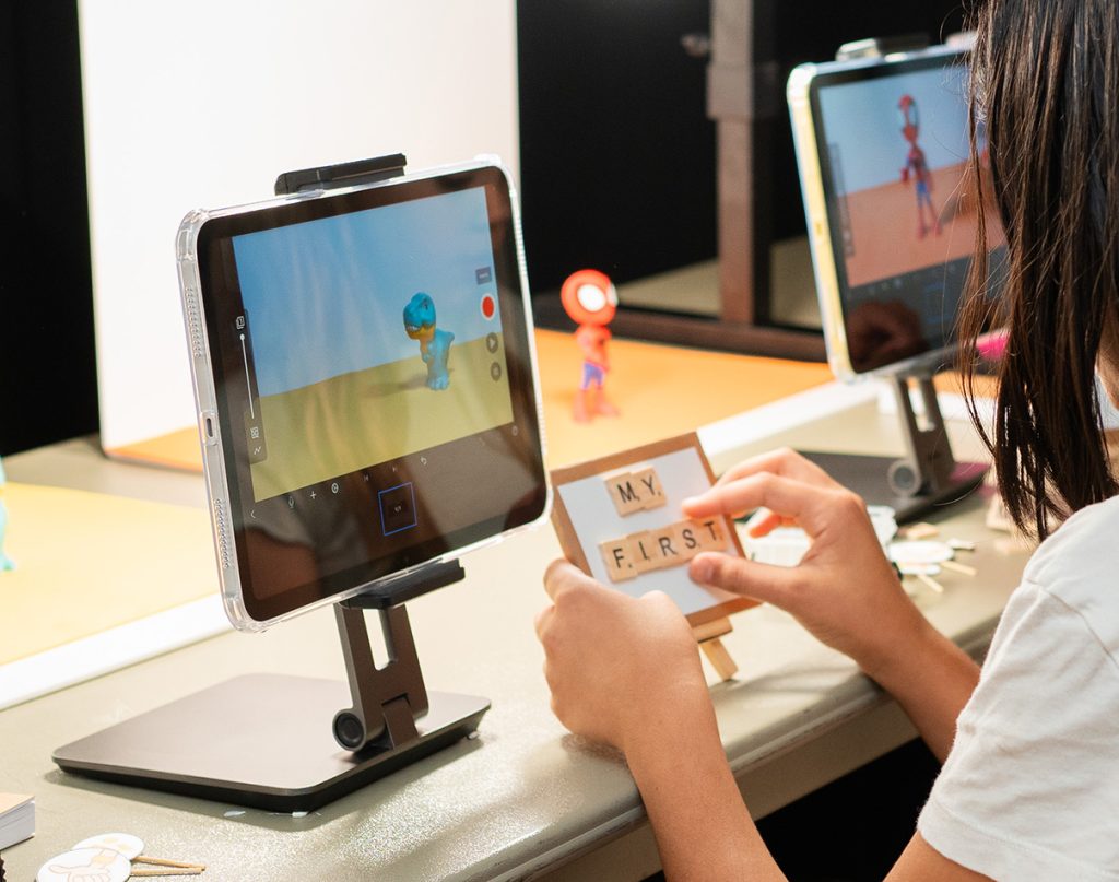 Home Page - free trials A child arranging letter tiles beside a tablet filming their first stop-motion film
