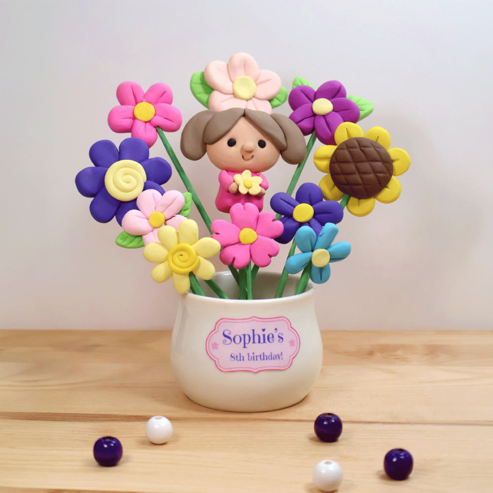 A clay Friendship Pot: a mini portrait surrounded by clay flowers